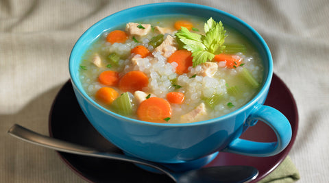 Chicken and Konjac Rice Soup made with GoSkinny Noodles Rice in blue cup bowl with spoon