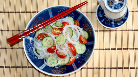 Refreshing Cucumber Noodles Salad made with GoSkinny Noodles Angel Hair on blue plate with red chopsticks