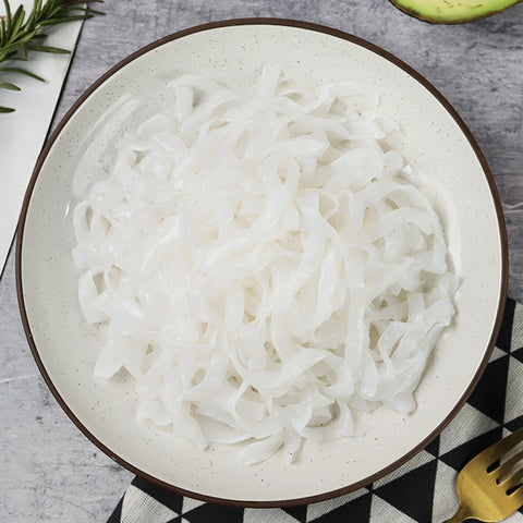 White plate with plain, low carb, organic GoSkinny Noodles Fettuccine shirataki